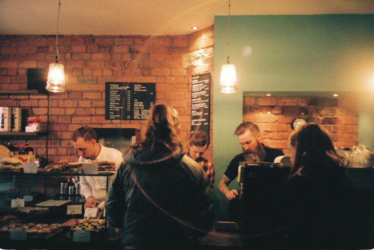 A bustling coffee shop in Leeds, England, with customers ordering and baristas preparing drinks.